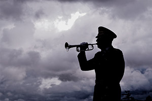 A person standing in front of a cloudy sky